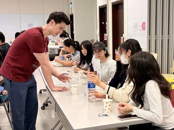 Professor William Choi engages with participants during the workshop on speech therapy.
