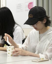 Participants practise mixing  thickened drinks during the workshop on speech therapy.